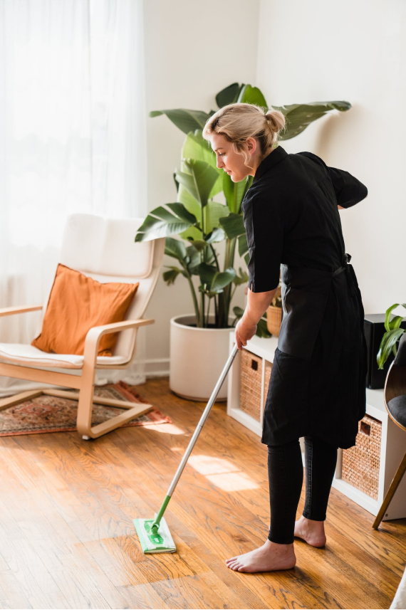 Woman cleaning the floor with a mop.
